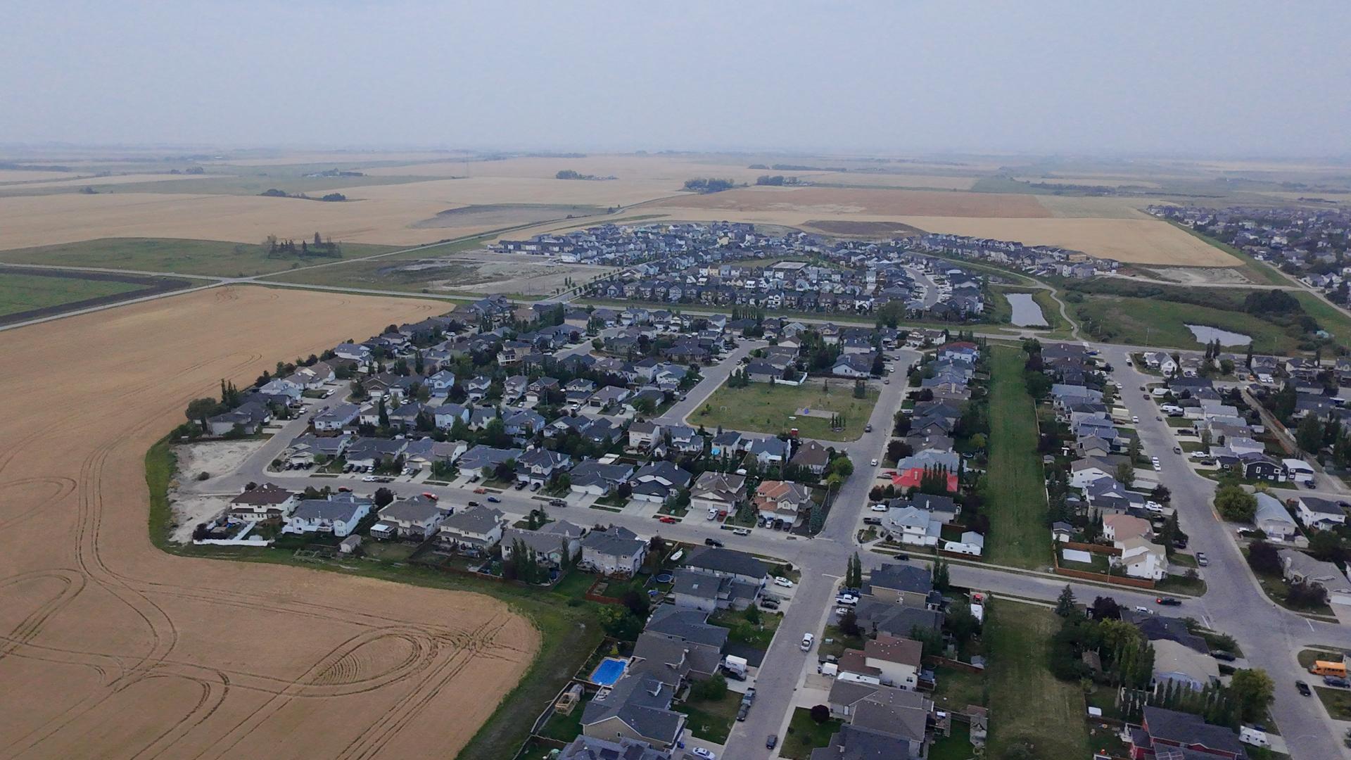 Arial of Homes along side a hay field