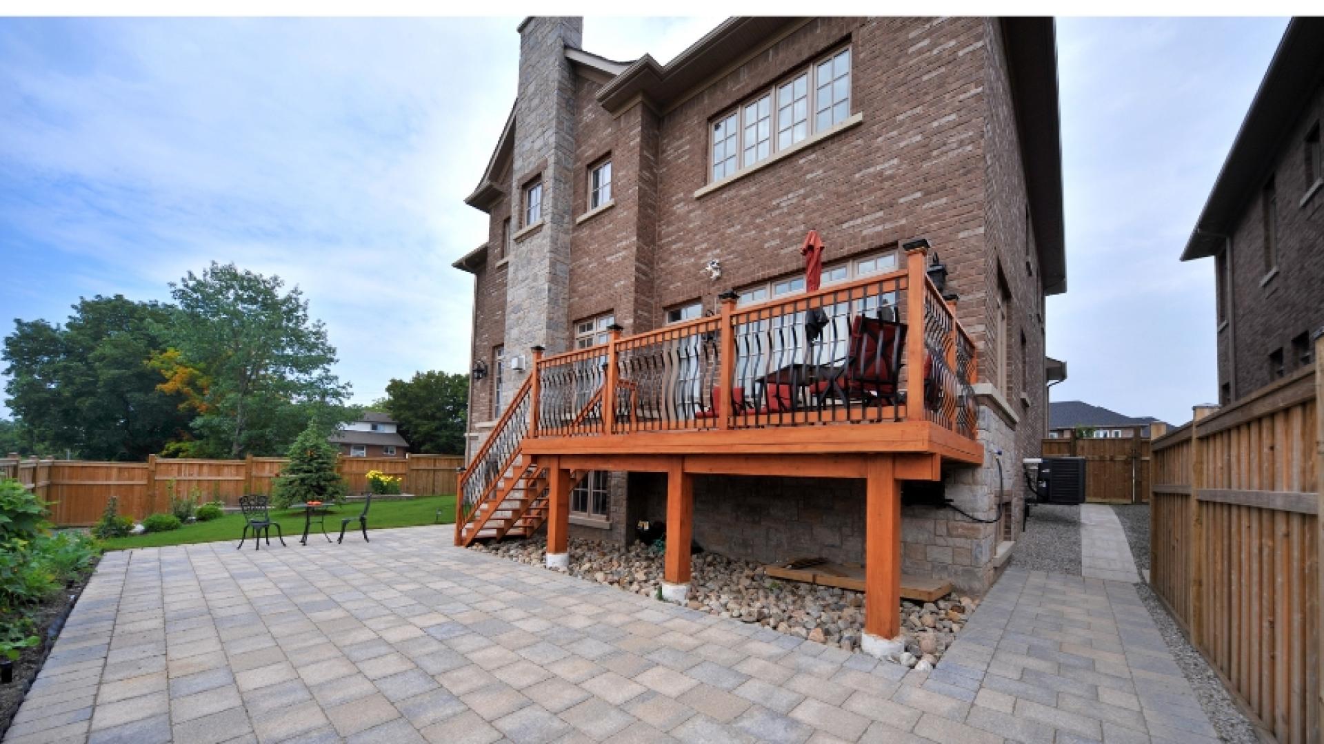 Back of house with a patio and deck