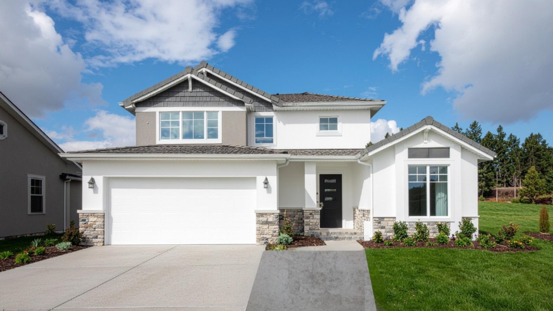 Front of house showing a driveway that has been widened